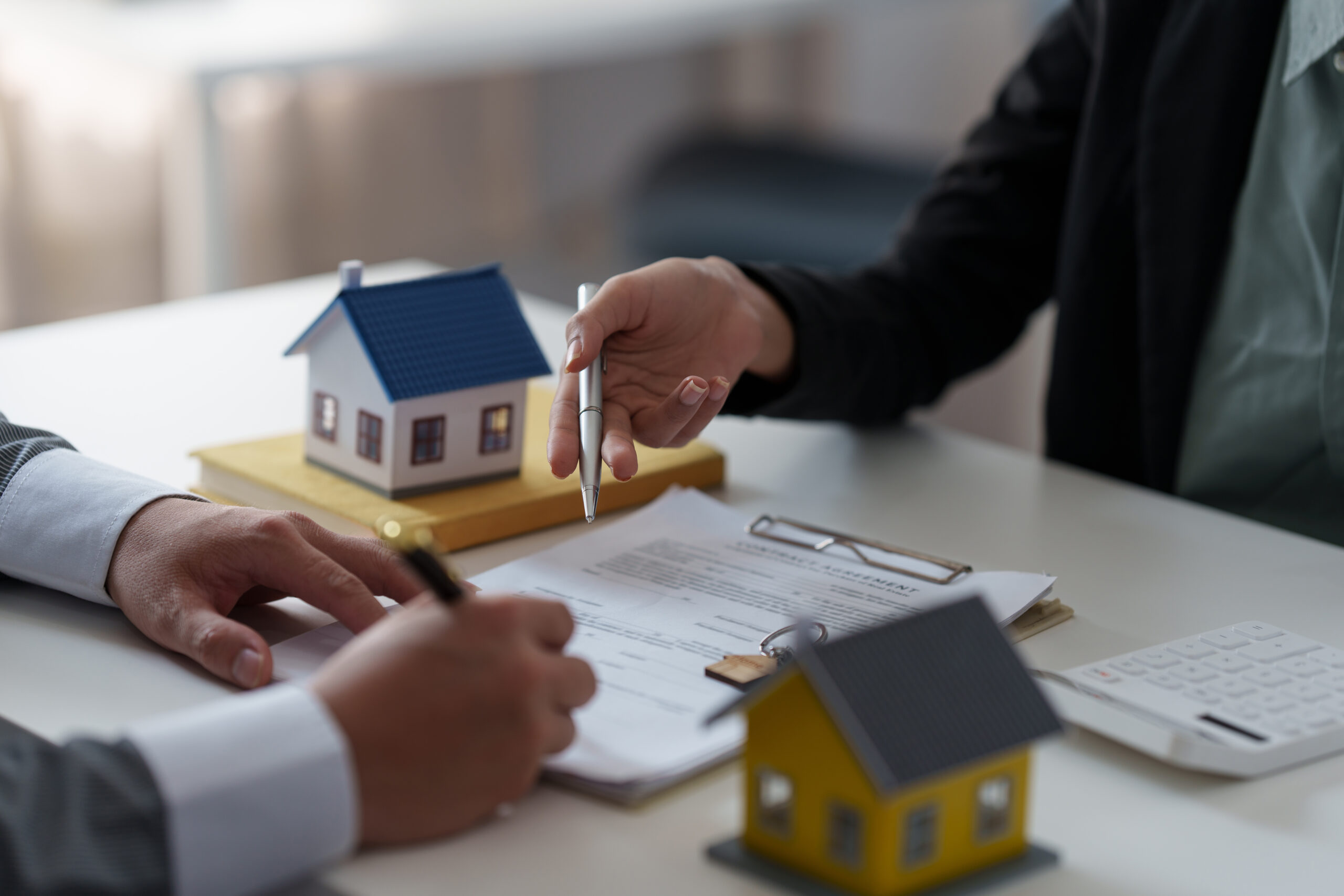 Close up Business woman or Real Estate agent explain signing agreement for buying house. Bank manager and real estate concept